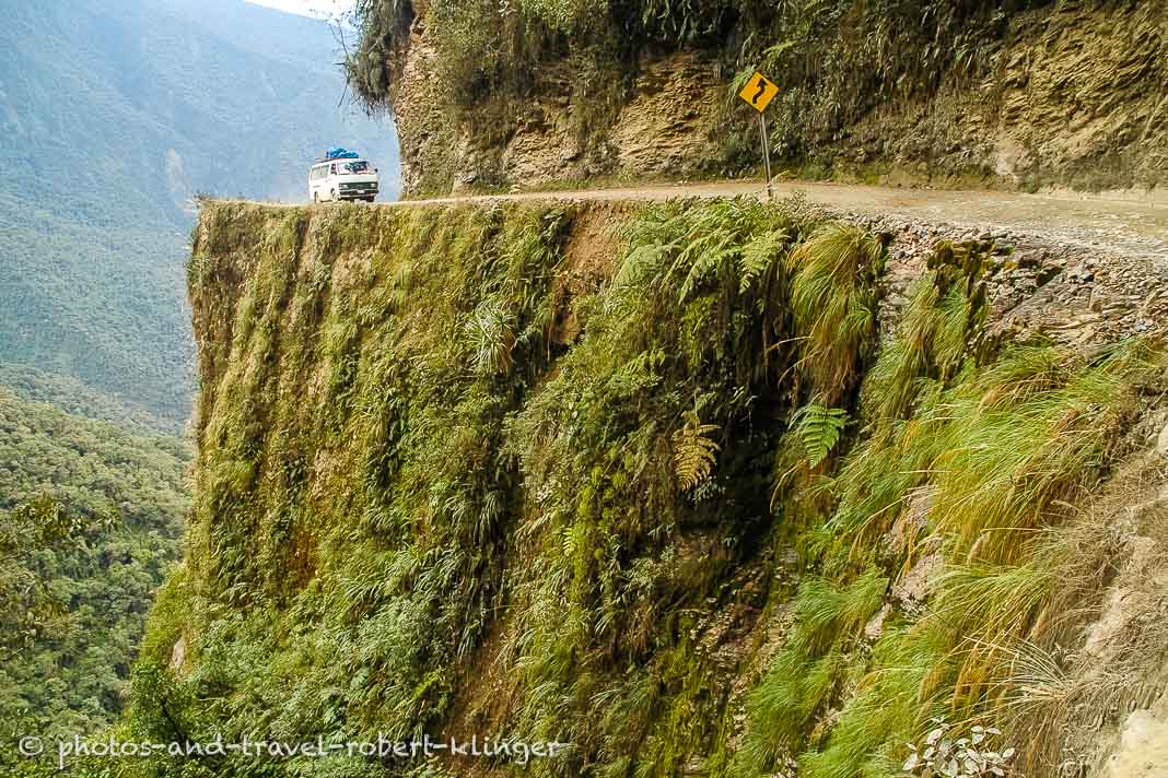A van driving on North Yungas road next to a high abysm