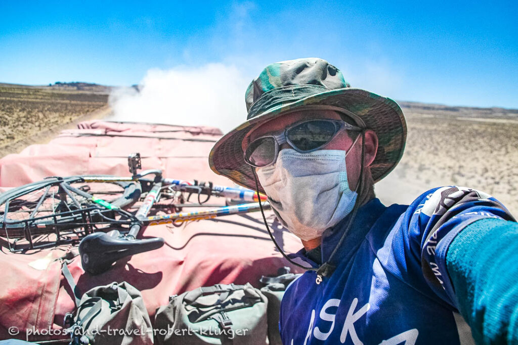 A cyclist with a broken bicycle on a truck