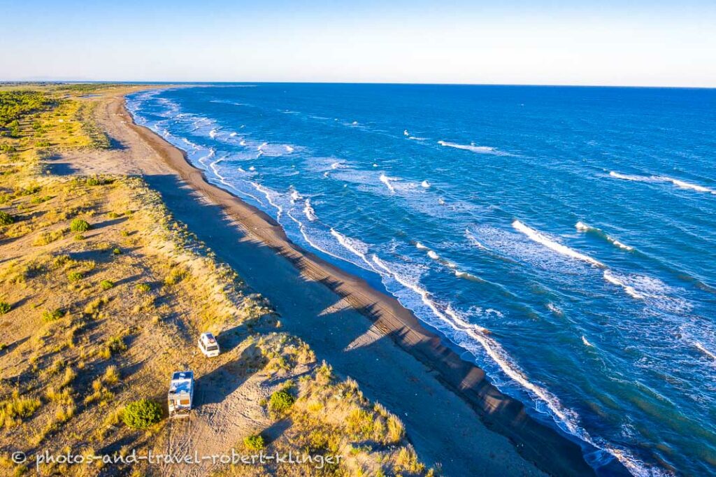 Two camping cars at the west coast of Albania photographed from a drone