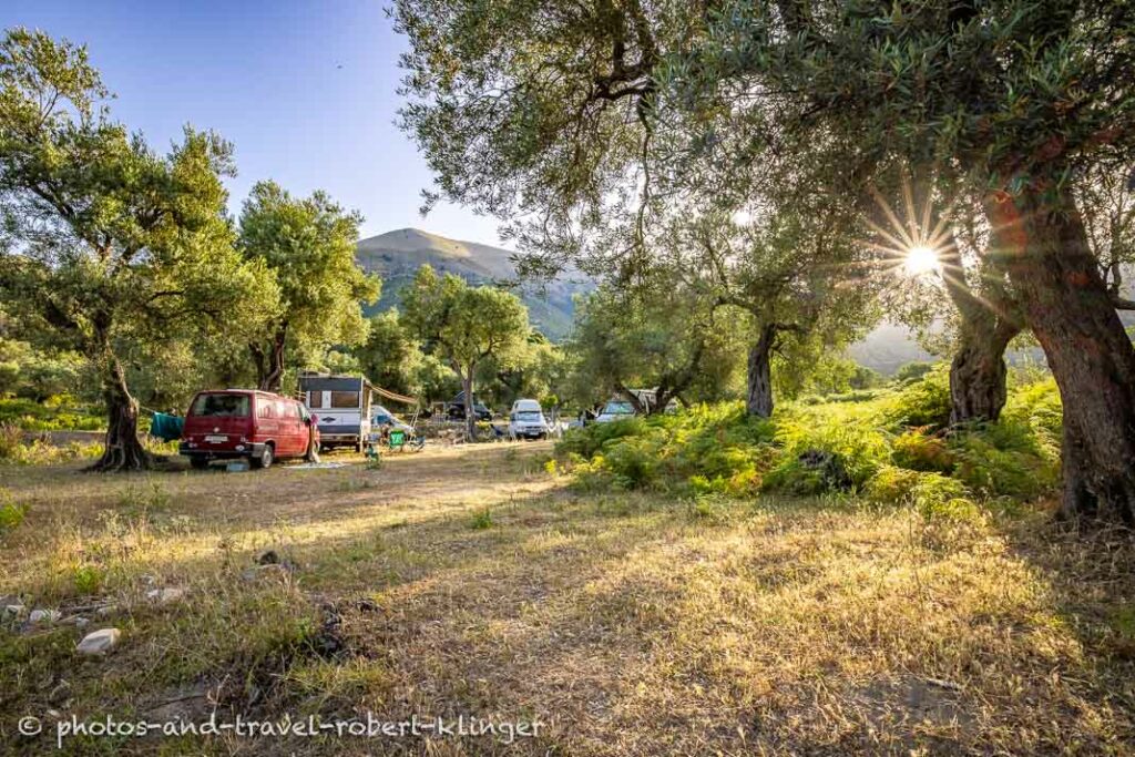 Camping cars are parked in the countryside of Albania during sunrise