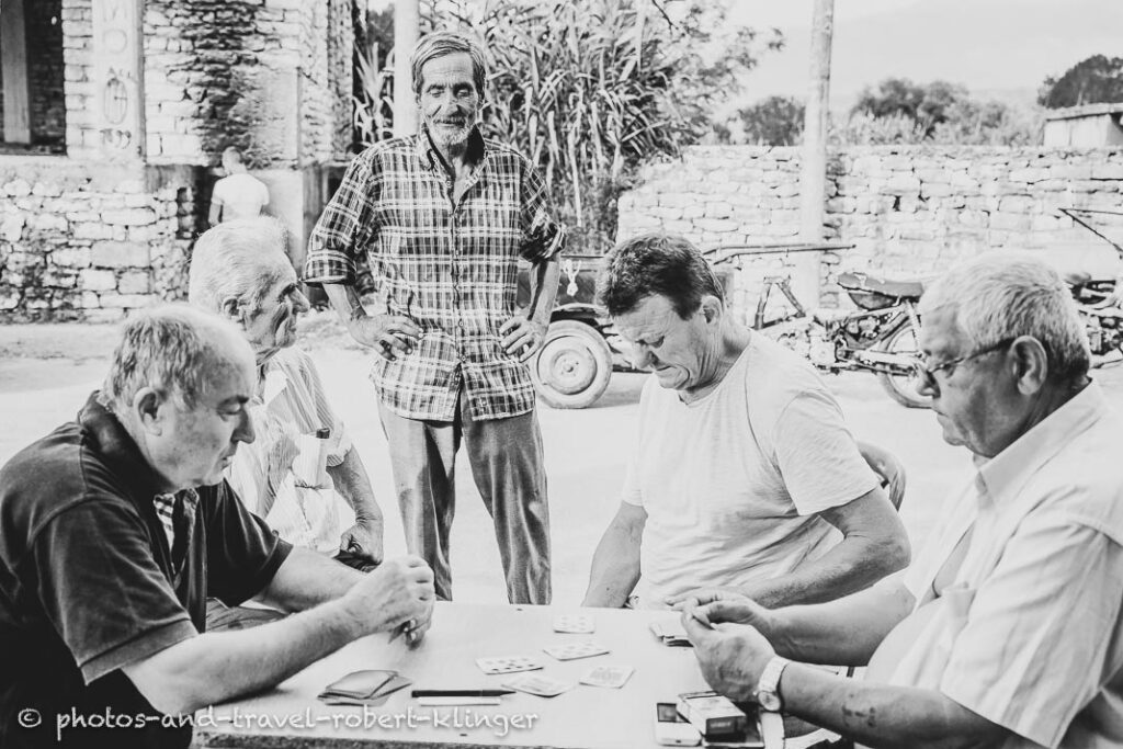 A group of men playing cards in Albania, black and white photo