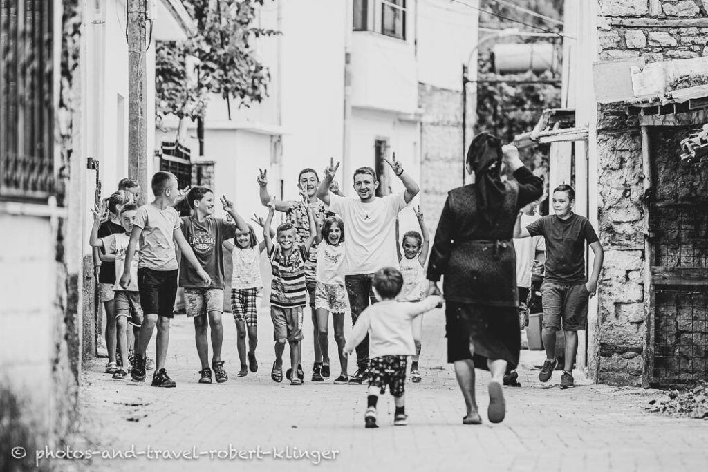 A group of children in a village in Albania, A vendor in his shop in Albania, black and white photo