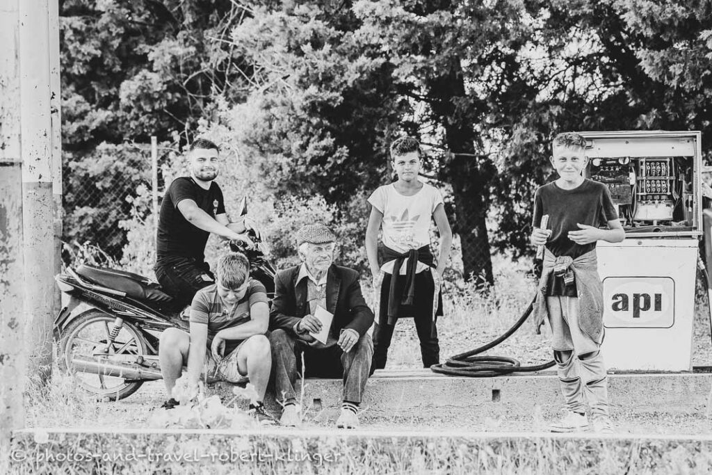 A old man and a few boys in Albania, black and white photo