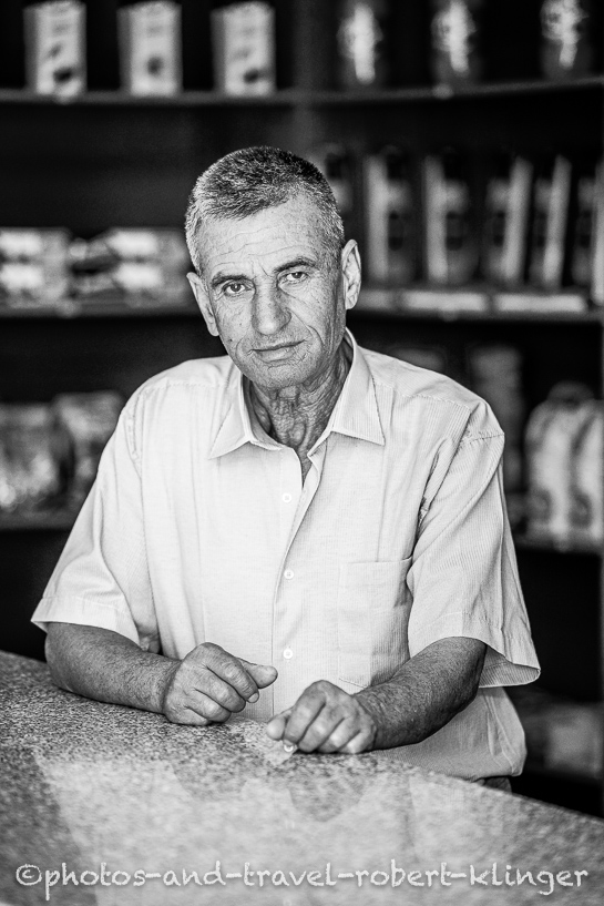A vendor in his shop in Albania, black and white photo