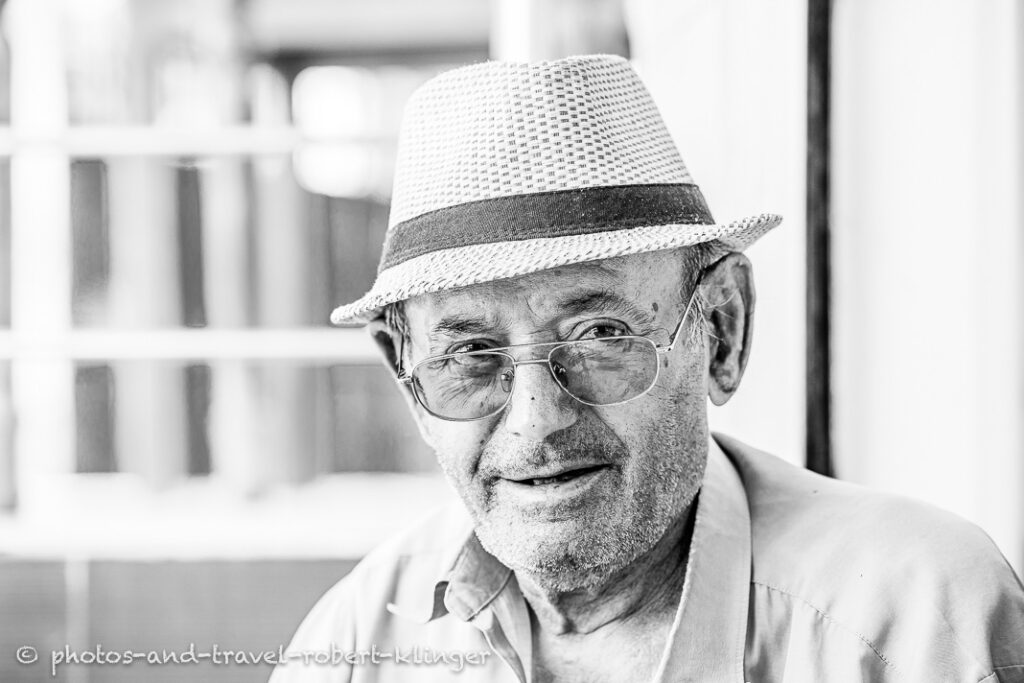 A man in Albania, A vendor in his shop in Albania, black and white photo