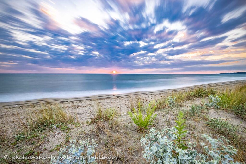 A landscape photo of a beach and a sunset in Albania