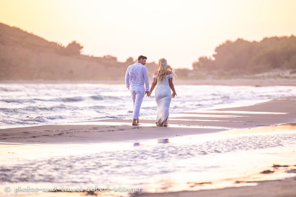 A wedding couple walking along the beach in Albania