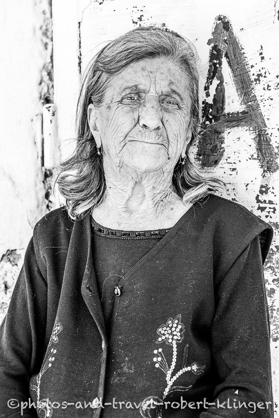 A travel portrait of a older woman in Albania, black and white photo