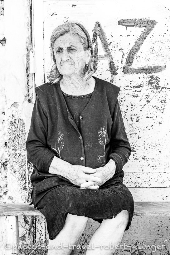 Travel portrait of on old woman in Albania, black and white photo