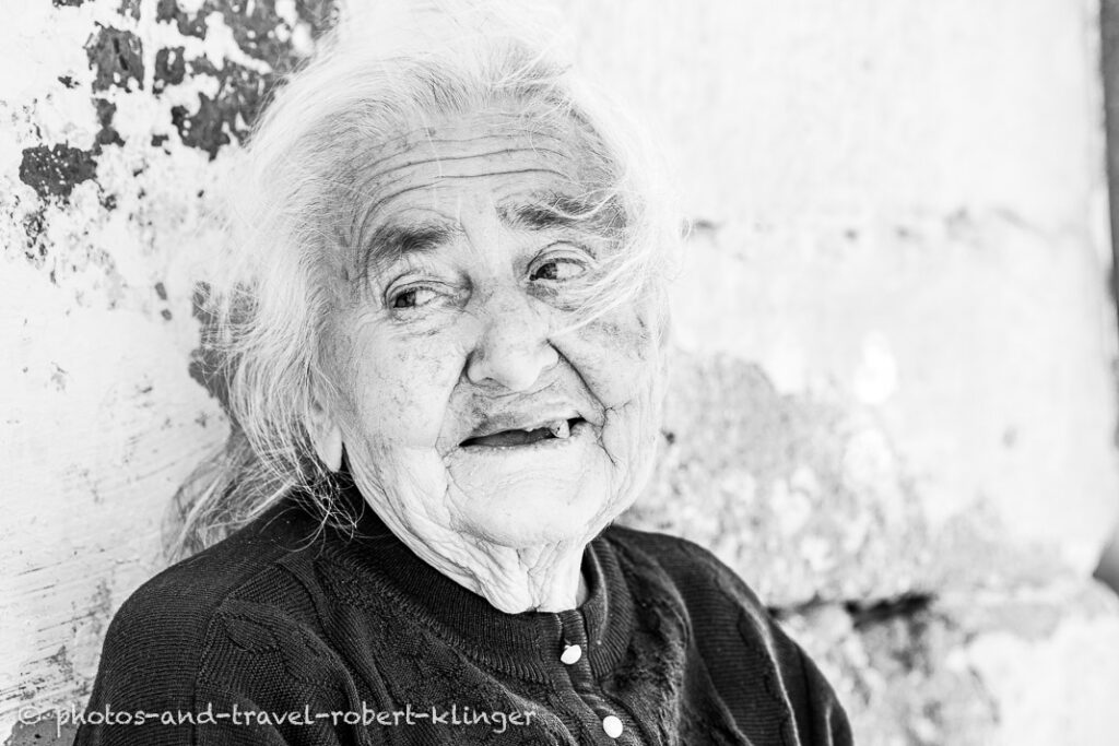 A travelphoto of a old woman in Albania, black and white photo