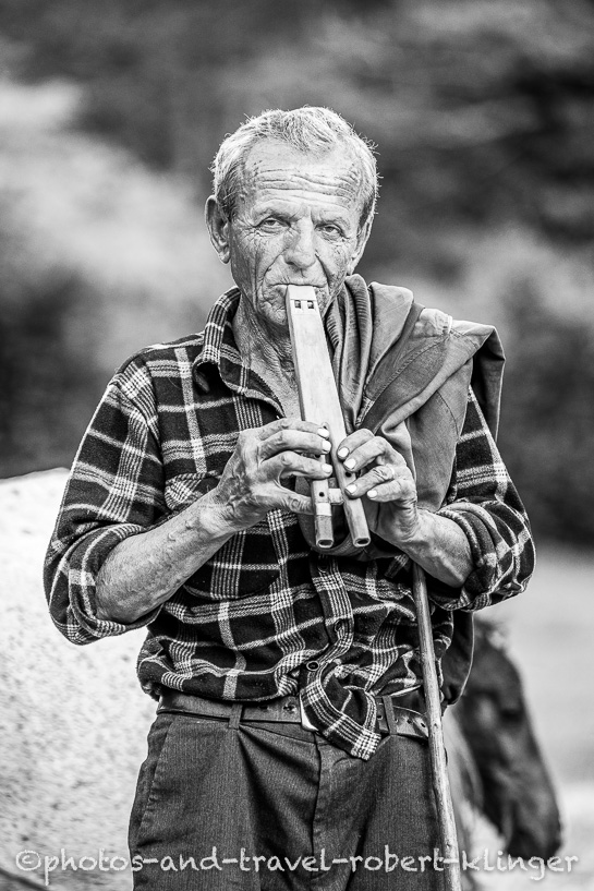 A farmer in Albania playing the whistle, black and white photo