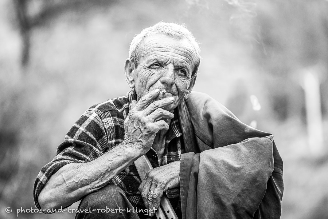 A old farmer smoking a cigarette in Albania, A farmer in Albania