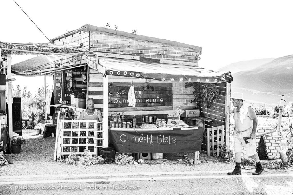 A restaurant and a shop in Albanie, black and white photo