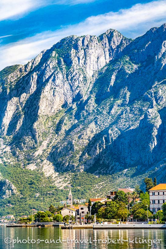 Houses and rough steep mountains along the bay of Kotor in MOntenegro