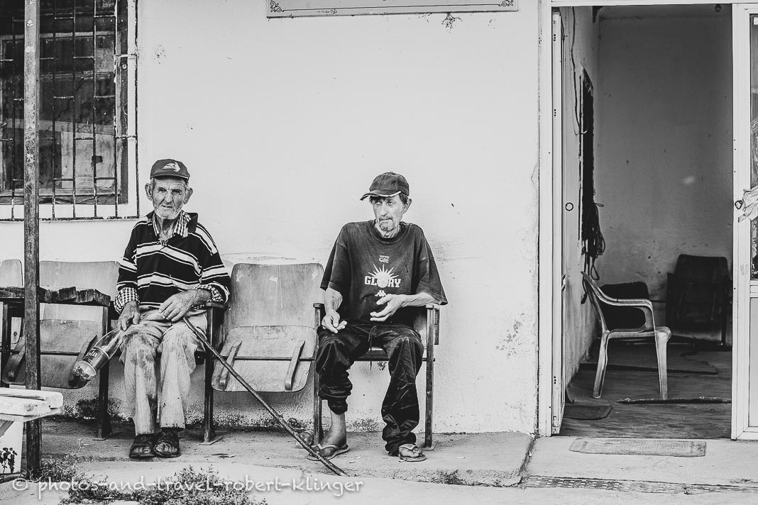 Two man sitting in front of a store in Macedonia