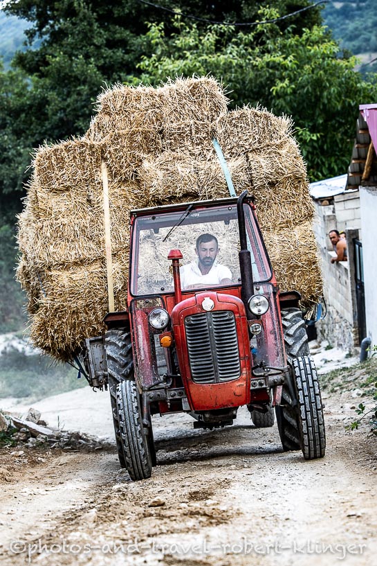 A tractor in a village in Northern Macedonia fully loaded with straw