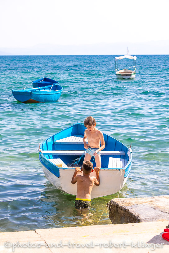 Two boys are playing in a rowboat in Ohrid