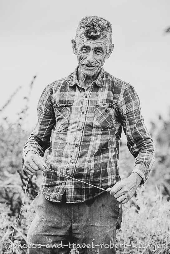 Black and white portrait of a friendly farmer in Northern Macedonia