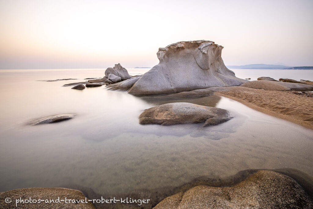 Long exposure photo of a beautiful limestone formation on a beach in Sithonia in Greece during sunrise