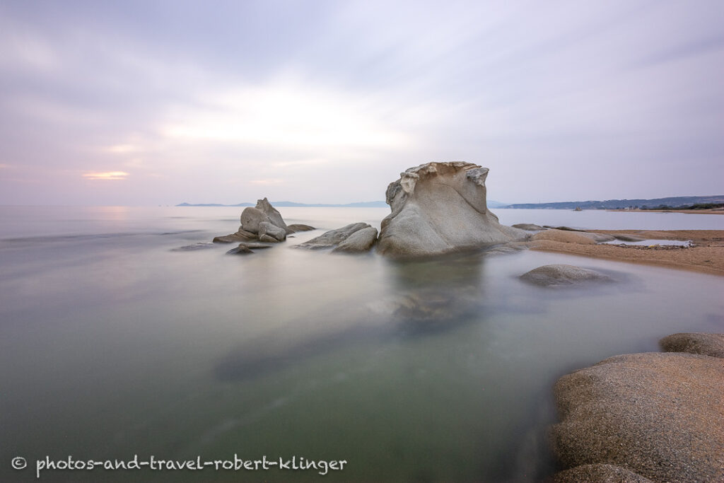 Long exposure photo of a beautiful limestone formation on a beach in Sithonia in Greece during sunrise