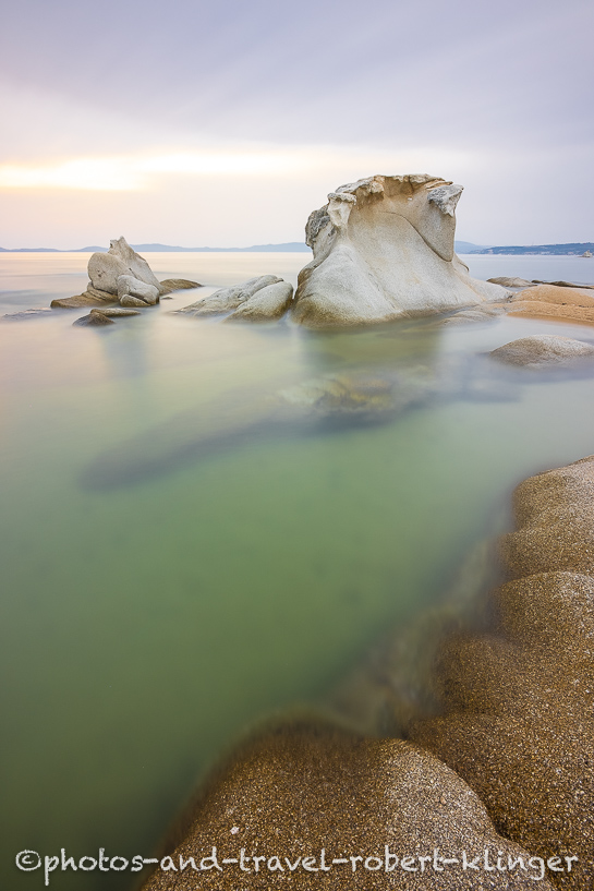 Long exposure photo of a beautiful limestone formation on a beach in Sithonia in Greece during sunrise