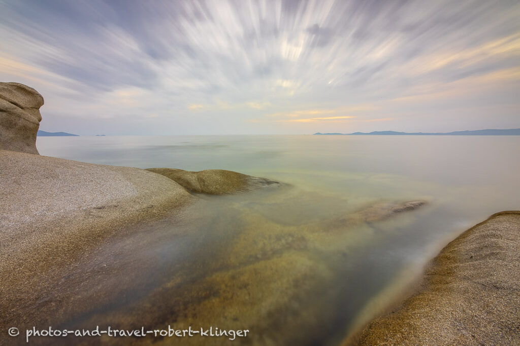 Long exposure photo of a beautiful limestone formation on a beach in Sithonia in Greece during sunrise