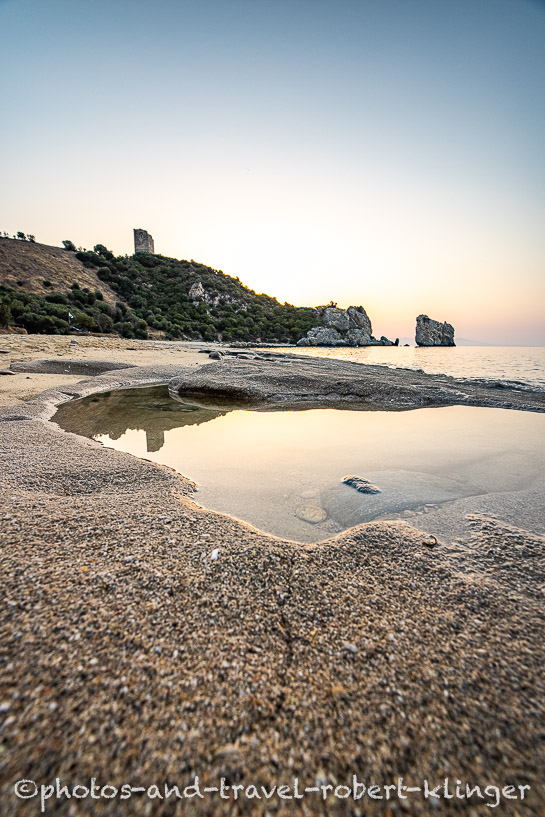 Long exposure photo of a sunrise on a stony beach in Greece