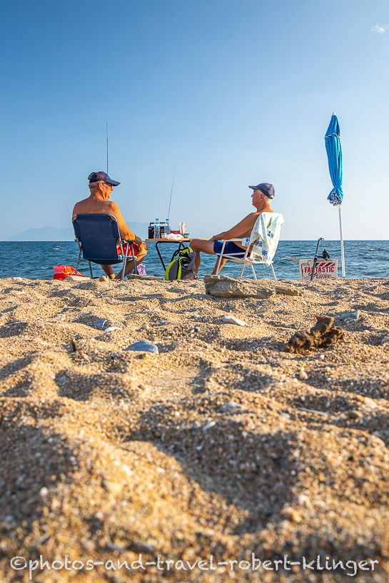Two old men sitting on a beach in eastern Greece and having a conversation