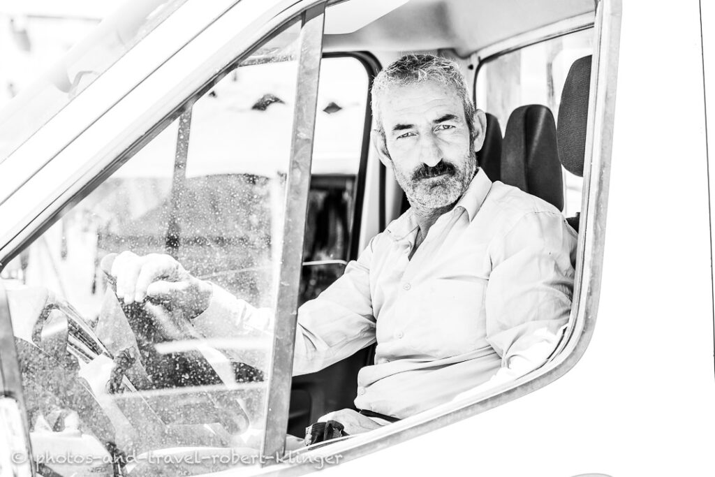 black and white portrait of a man sitting in a van in Turkey