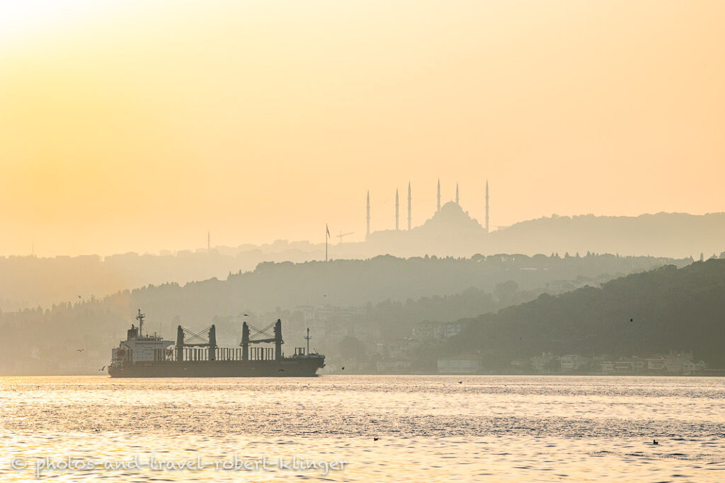 A big ship and a huge mosque during sunrise in Istanbul
