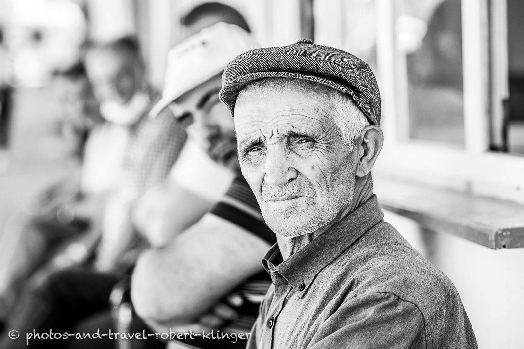 A turkish man in front of a tearoom, black and white portrait