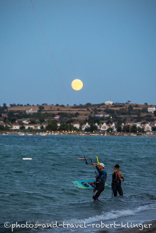 Two Kitesurfers in Turkey during moonlight