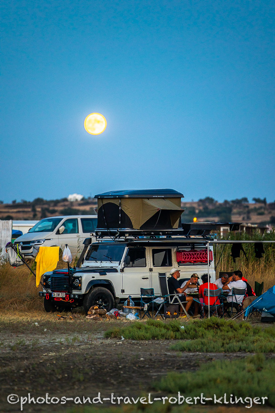 A beautiful landrover defender is being parked during full moon at the turkish aegean coast
