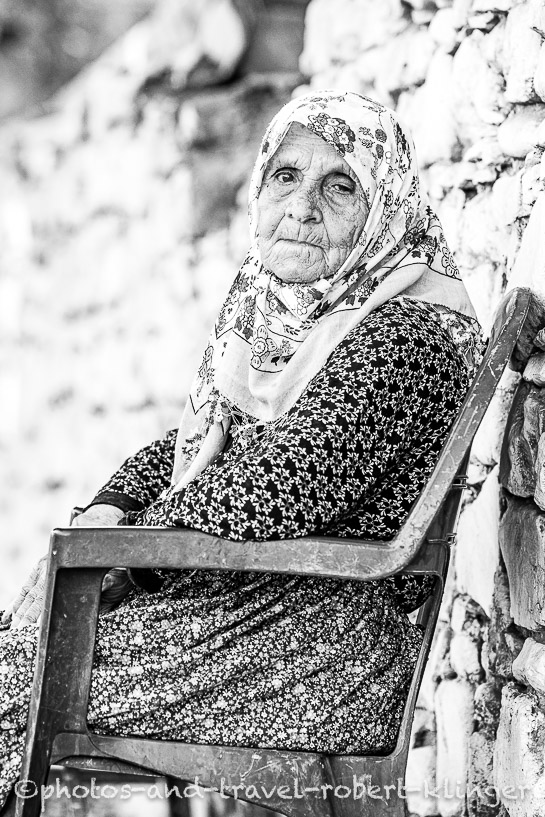 A black and white portrait of a old turkish woman