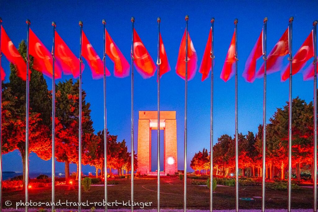 The Çanakkale Martyrs' Memorial and many turkish flags during the blue hour