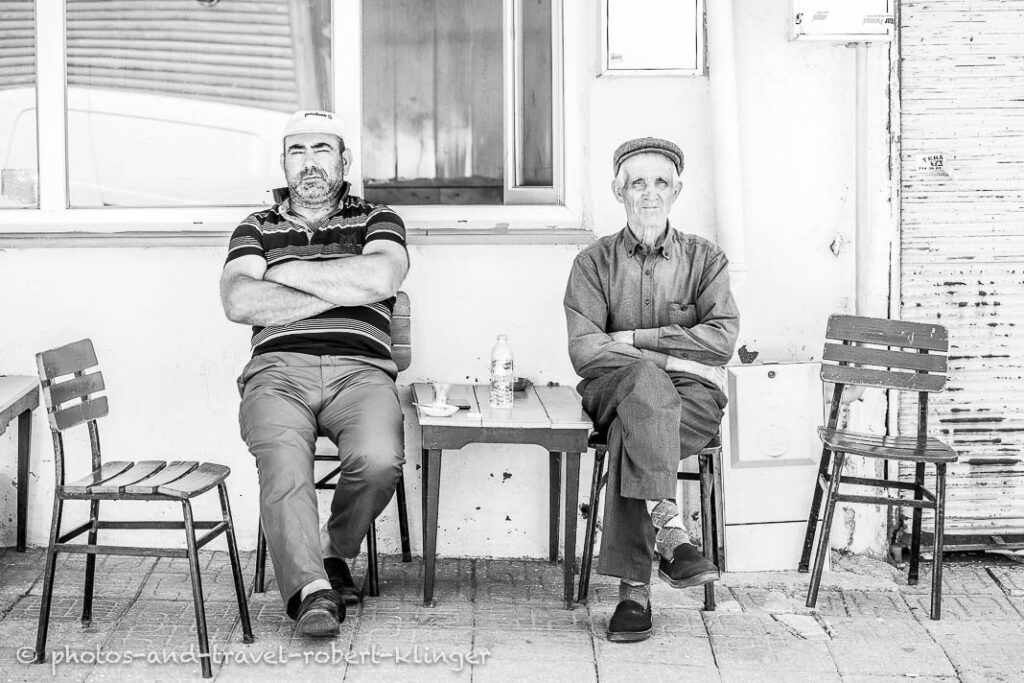 Black and white photo of two men sitting in a tearoom in Turkey