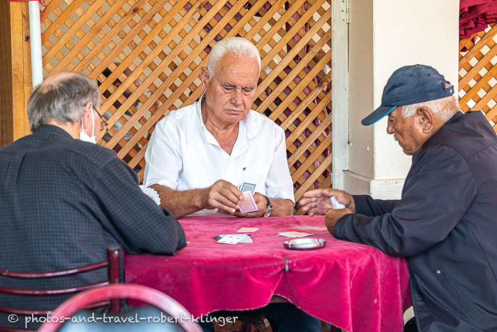 Three turkish men playing cards in a tearoom in Turkey
