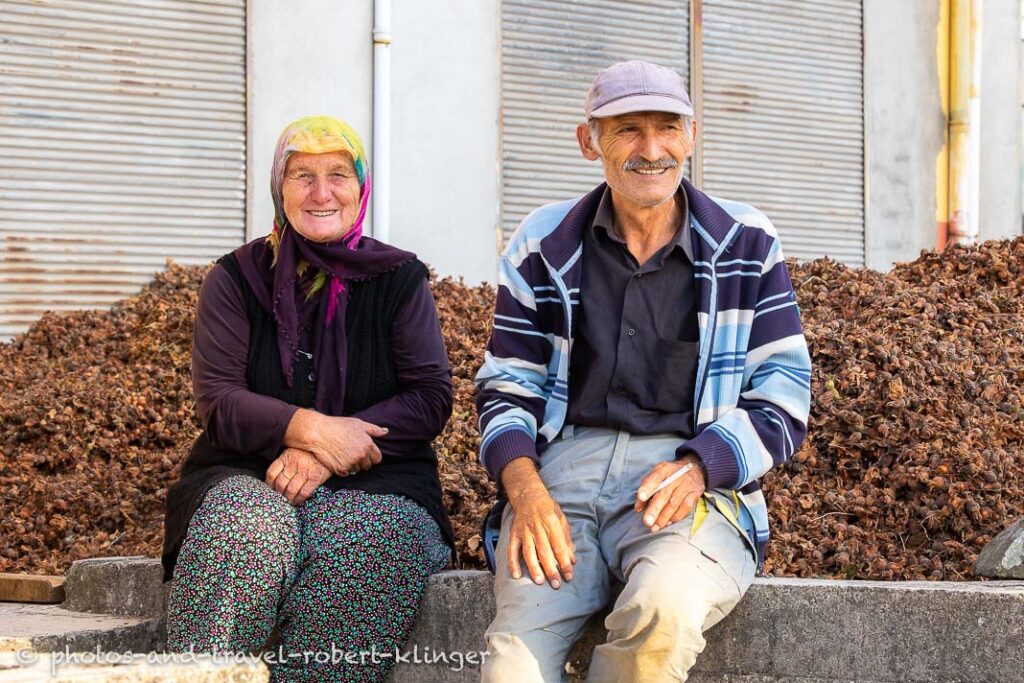 A happy turkish couple smiling after a long day of hazelnut harvesting