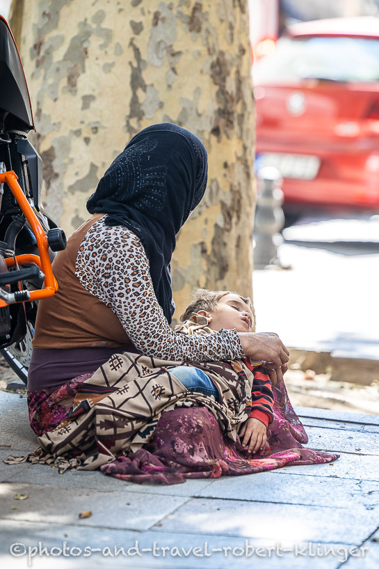 A woman and her little son begging on a road in Istanbul