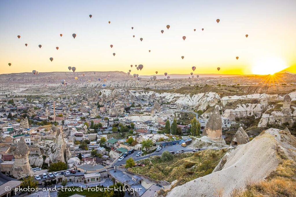 Many hot air ballons over Göreme during sunrise