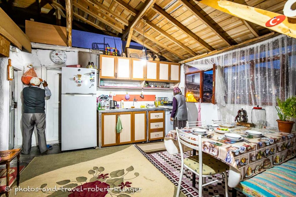 A turkish woman cooking in her kitchen and her husband working in Korgun