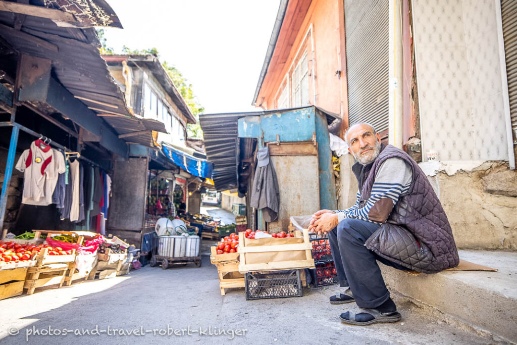 A man sitting next to his shop on a market in Ankara