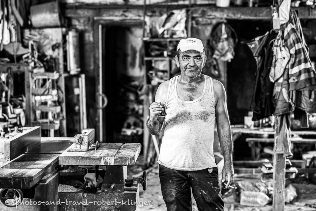 A boatbuilder having a tea in his workshop in Tukrkey