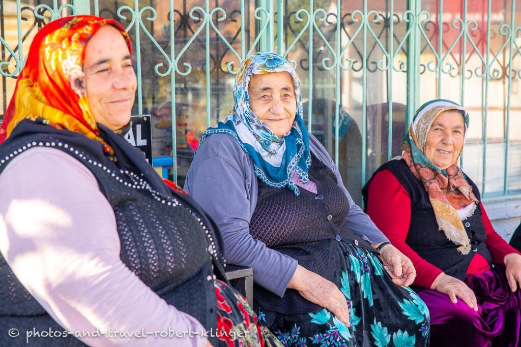 Three old woman sitting in front of a store in the Ihlara Valley