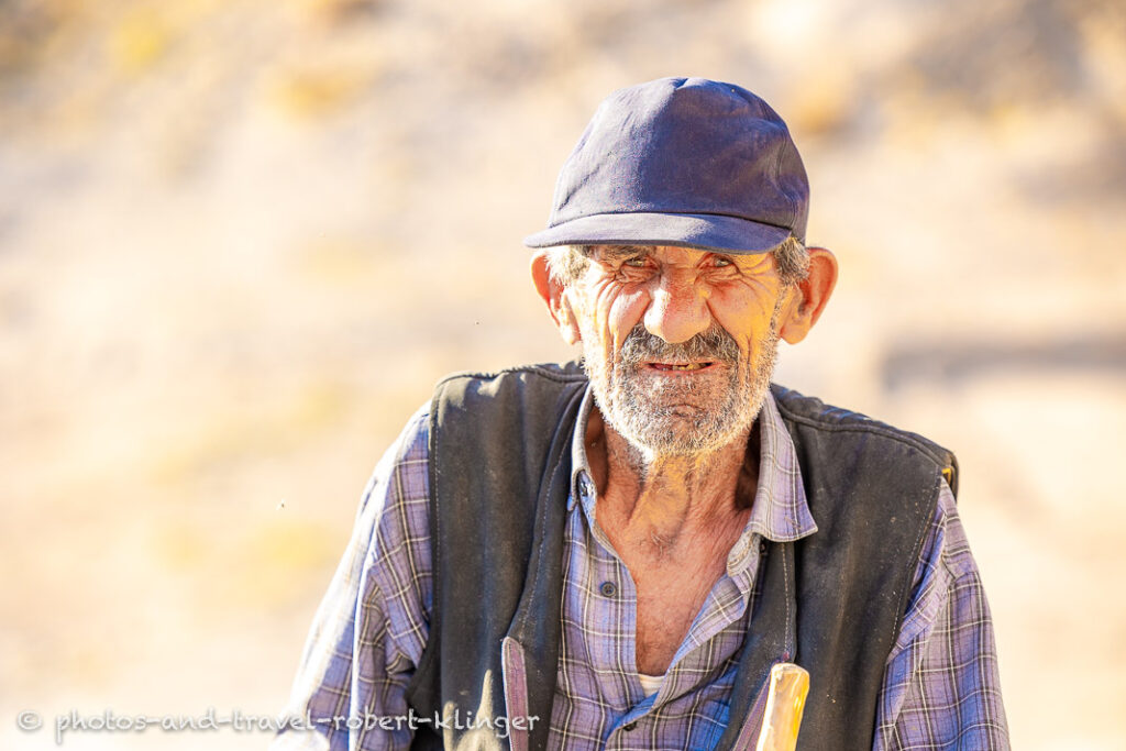 A man on a donkey in the Ihlara Valley chasing a cow