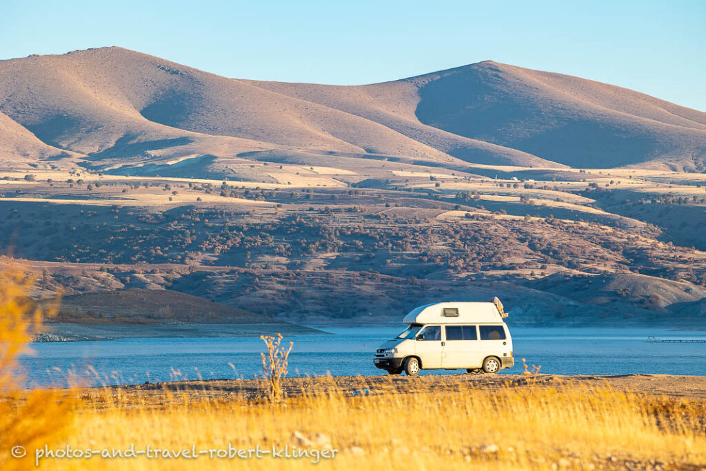 A white Vokswagen van being parked at a lake in eastern Anatolia in Turkey