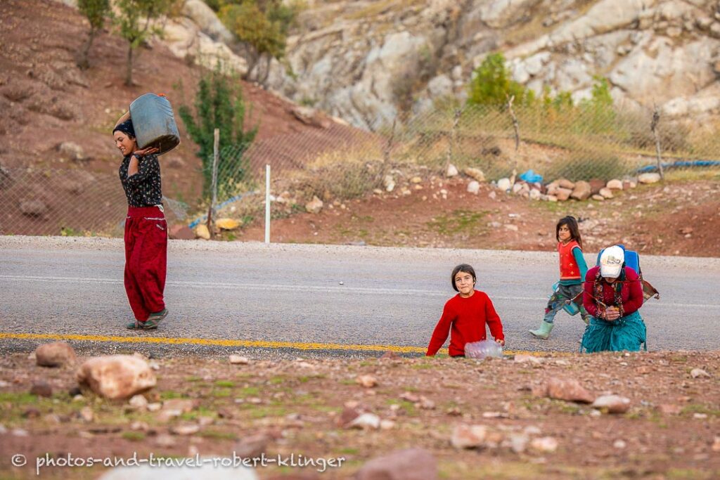 A woman and three girls carrying water in Kurdistane, Turkey