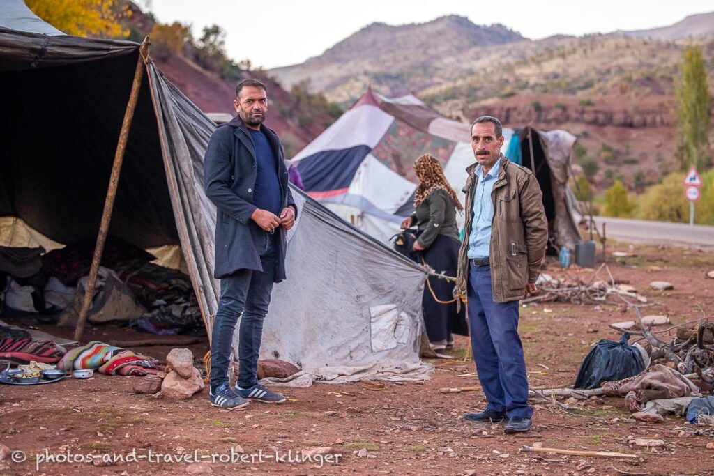 Two men are standing in a camp in Kurdistane