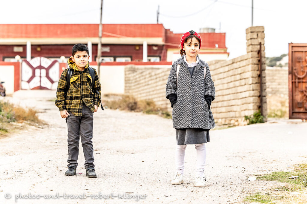 A boy and a girl on the way to school in Iraq