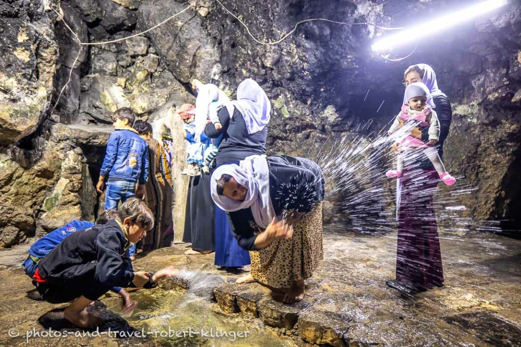 Yezidis inside the Lalish temple in Iraq at the holy waters